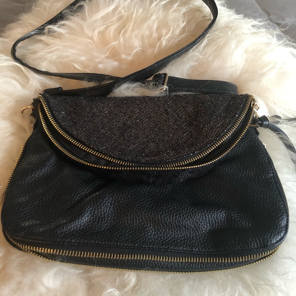 Black leather adjustable cross body purse.
